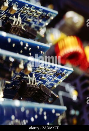 Circuit boards. Printed circuit boards with electronic components attached. A circuit board connects components such as microchips, transistors, diode Stock Photo