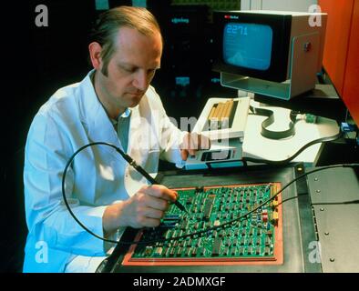 Circuit board test. Technician testing a printed circuit board. The circuit board has been connected to an automatic assembly testing system. By conne Stock Photo