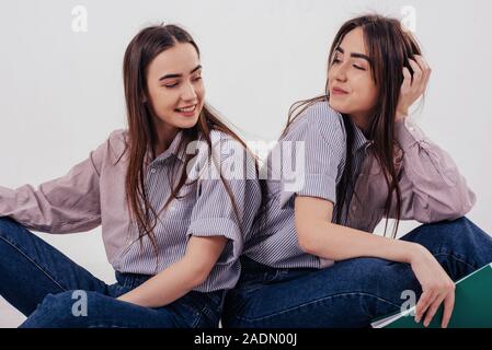 Premium Photo | Two sisters pose in the studio on a purple background 2  beautiful women in black fancy dresses gathered for a party