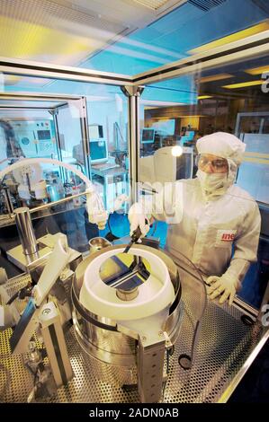 MODEL RELEASED. MEMS production. Clean room technician using photolithography processes to produce MEMS (microelectromechanical systems) devices. MEMS Stock Photo