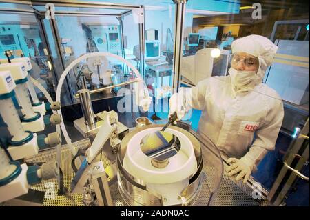 MODEL RELEASED. MEMS production. Clean room technician using photolithography processes to produce MEMS (microelectromechanical systems) devices. MEMS Stock Photo