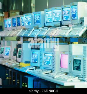 Computer room in a university. Rows of computer monitors, keyboards and vertical processor units. Stock Photo