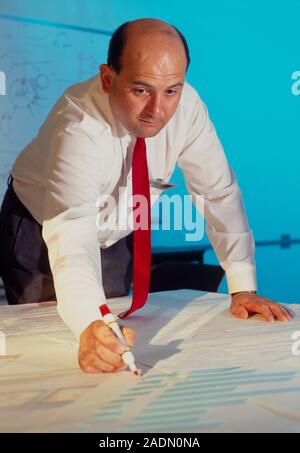 Computer software development. Computer programmer designs computer software using a schematic representation of the program. The term 'software' appl Stock Photo