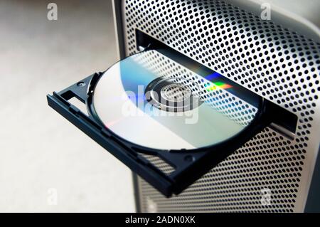 Optical disc drive on a desktop computer. The disc in the drive is either a CD (compact disc) or DVD (digital versatile disc). Stock Photo
