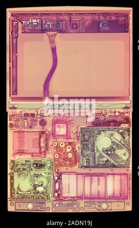Laptop computer. Coloured X-ray of a laptop computer. The computer's screen is in upper frame (pink). Most of the components are seen in lower frame. Stock Photo