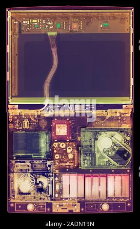 Laptop computer. Coloured X-ray of a laptop computer. The computer's screen is in upper frame (dark blue). Most of the components are seen in lower fr Stock Photo