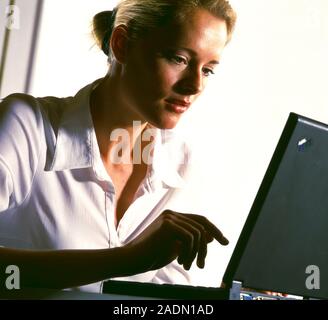 Laptop computing. Woman using a laptop computer. Stock Photo
