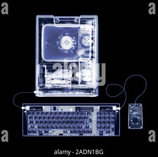 Desktop computer. X-ray of an Apple Macintosh Classic computer. The computer's screen (top centre), hard drive and central processing unit (CPU, centr Stock Photo