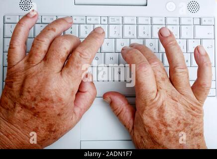 Keyboard use. Elderly woman typing on a laptop keyboard. Stock Photo