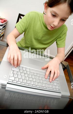 Girl using a laptop computer. Stock Photo