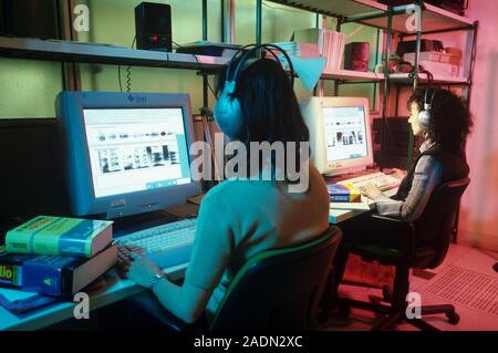 Voice application software. Software engineers developing a multilingual interactive voice application platform. They are analysing sound wave pattern Stock Photo