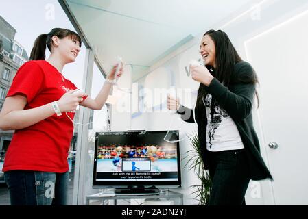 MODEL RELEASED. Nintendo Wii. Shop staff demonstrating the Nintendo Wii video game console at a launch in a computer games store. Each player is holdi Stock Photo