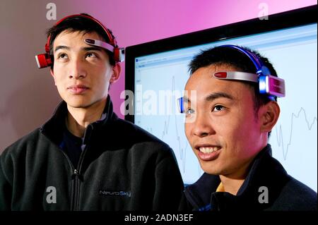 MindSet brainwave-reading headset. Two people wearing a Mindset brain-computer interface (BCI) headset developed by Neurosky Inc., San Jose, USA. The Stock Photo