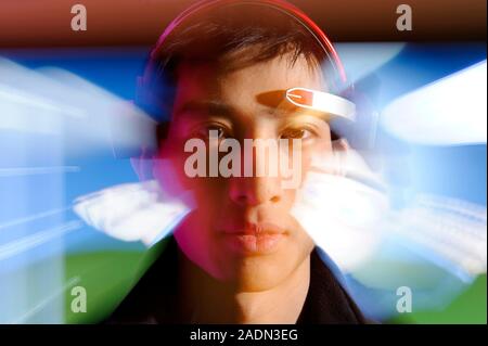 MindSet brainwave-reading headset. Zoom lens photographic effect of a person wearing a Mindset brain-computer interface (BCI) headset. This headset wa Stock Photo