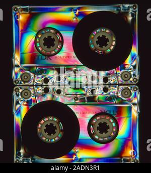 Stress patterns in audio tape cassettes with clear plastic cases, revealed by photopolarimetry. When plastic objects are manufactured, internal stress Stock Photo
