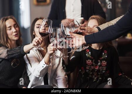 Let's drink for our happiness. Family friends having nice time in beautiful luxury modern restaurant Stock Photo