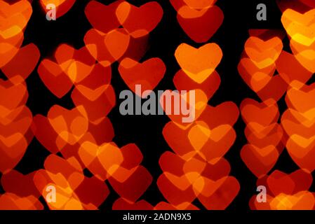 heart shaped orange and yellow bokeh on black background Stock Photo