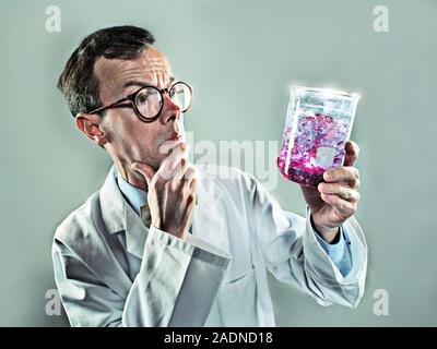 Chemistry. Chemist examining a chemical substance in a beaker. Stock Photo