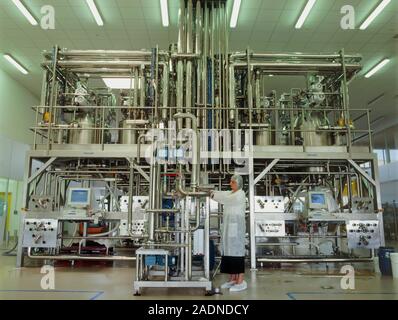 Cosmetics factory. Worker adjusting machinery at a cosmetics factory. This is the Shiseido factory in Orleans, France. Stock Photo