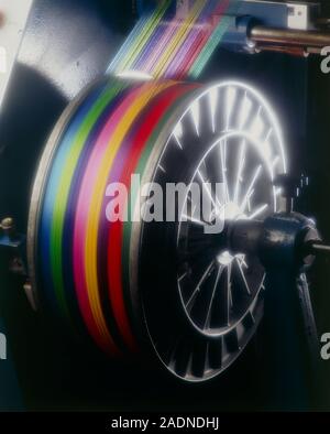 Weaving thread. View of a roll of coloured thread in a weaving mill. The thread is being used to make multicoloured fabrics. Stock Photo