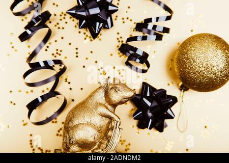 Creative flat lay composition with golden mouse and space for text on golden background. 2020 Stock Photo