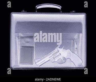 Handgun in briefcase. Simulated X-ray of a briefcase containing a handgun (lower centre to lower right). Also seen are two wallets (lower left) and tw Stock Photo