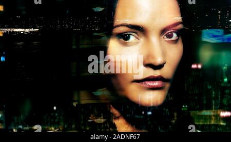 MODEL RELEASED. Face recognition. Conceptual image of a biometric security system represented by a woman's face being scanned. Stock Photo