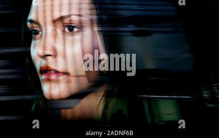 MODEL RELEASED. Face recognition. Conceptual image of a biometric security system represented by a woman.s face being scanned. Stock Photo