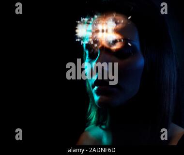 MODEL RELEASED. Mind reading. Conceptual image of a woman's thoughts being scanned represented by light over her head. Stock Photo