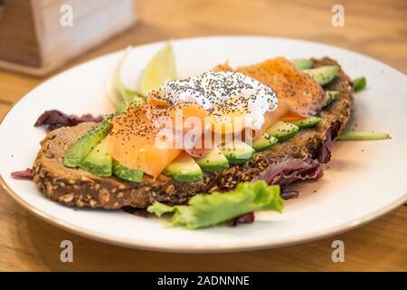 Avocado toast with poached egg and salmon, Mafrens Food, Madrid, Spain Stock Photo