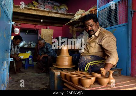 Potter working on his pottery wheel at his workshop. Stock Photo