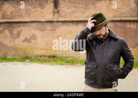 man with jacket and hat in the street Stock Photo