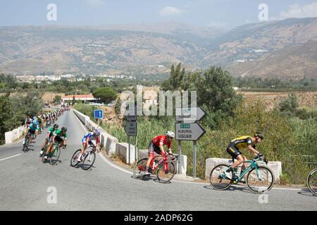 Cyclists competing in the Vuelta de España road race crossing the bridge over the river Guadalfeo near Orgiva, Granada, Andalusia, 29 August 2018. Stock Photo