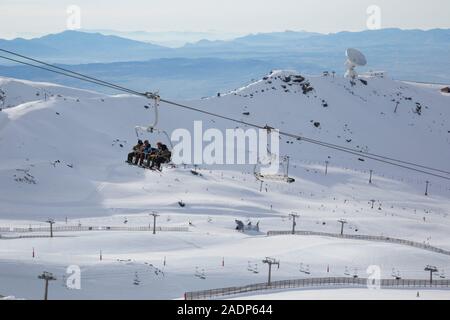 Chairlifts, pistes and the IRAM radio astronomy telescope in the Borreguiles area of the Sierra Nevada ski slopes, Granada, Andalusia, Spain Stock Photo