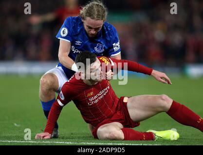 Liverpool's Andrew Robertson (left) and Everton's Tom Davies clash during the Premier League match at Anfield, Liverpool. Stock Photo