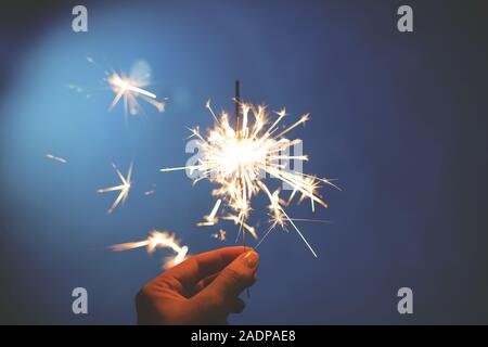 Bengal fire -sparcler on a blue background. Element of decorations for celebrations and holidays. Stock Photo