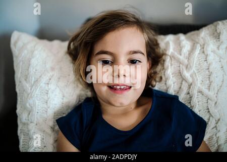 Beautiful smiling 4 yr old girl with dark eyebrows and brown eyes Stock Photo