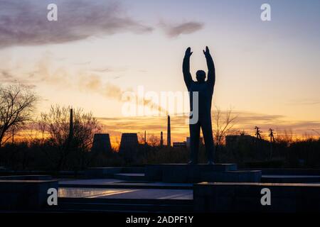 Baikonur, Kazakhstan - November 5, 2019: Giant statue of cosmonaut Yuri Gargarin with raised hands at Gagarin park at sunset Stock Photo