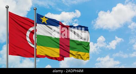 Tunisia and Central African Republic flag waving in the wind against white cloudy blue sky together. Diplomacy concept, international relations. Stock Photo
