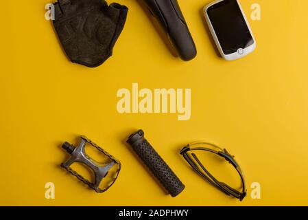 Bicycle, Cycling accessories on the yellow background. view from above Stock Photo