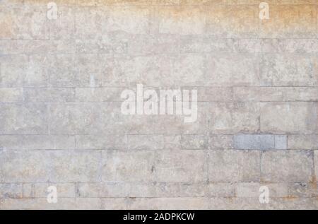 Old and weathered wall made of stone blocks. High resolution full frame textured background. Stock Photo