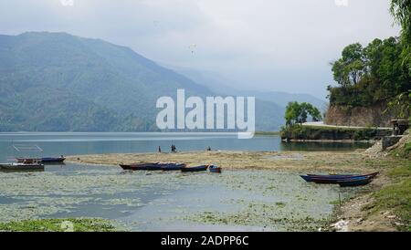 Phewa Lake a Cloudy Day and wooden color Boats Stock Photo