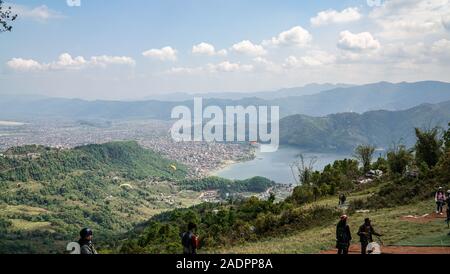 Paragliders flying against the Himalayas , Pokhara , Nepal. Stock Photo