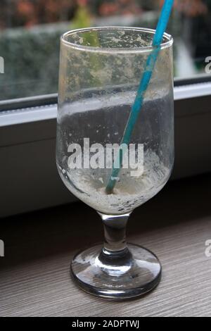 Empty coffee glass with a straw. Empty ice coffee glass. Stock Photo