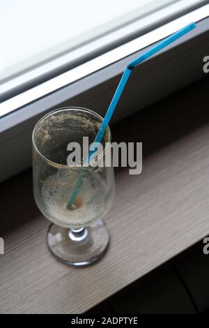 Empty coffee glass with a straw. Empty ice coffee glass. Stock Photo