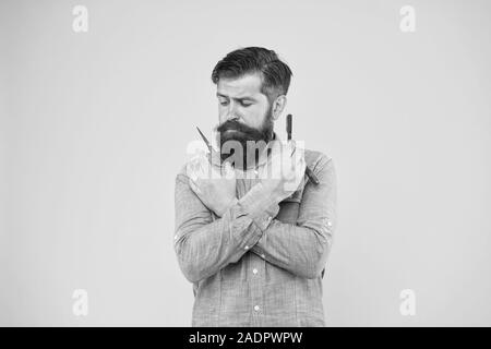 Classy and fabulous. Retro barbershop. Hipster with tools. Designing haircut. Fresh hairstyle. Barbershop concept. Barbershop salon. Personal stylist barber. Bearded man hold razor and scissors. Stock Photo