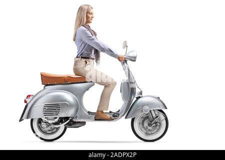 Full length profile shot of a woman in formal clothes riding a motorbike isolated on white background Stock Photo