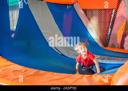 Little boy have fun jumping on trampolines Stock Photo