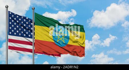 United States and Ethiopia flag waving in the wind against white cloudy blue sky together. Diplomacy concept, international relations. Stock Photo