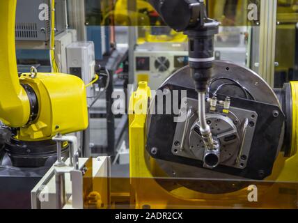 6 axis industry robotic arc machine welding nipple to pipe Stock Photo